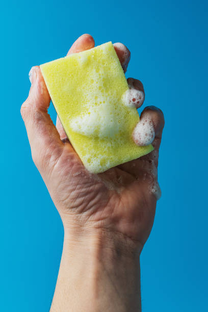 istock Dish detergent. Washing sponge in a person's hand 1798757597