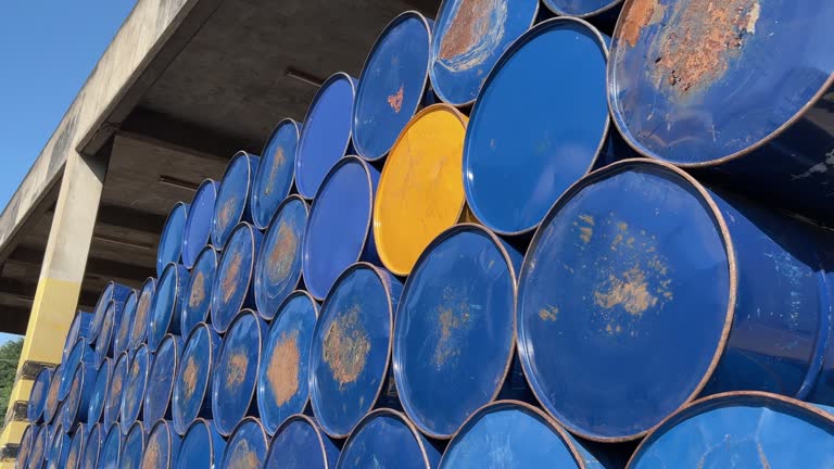 Group of stacked barrels with motor oil lubricant in warehouse