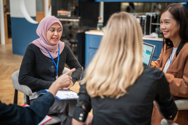 istock Converging Minds: Multicultural Businesswomen in Discussion at a Modern Office 1798848331