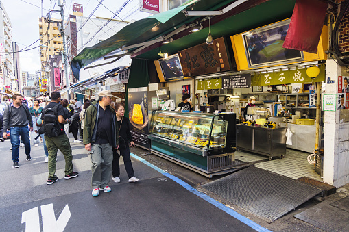 Tokyo, Japan - April 12, 2023: street scene on Tsukiji Fish Market with unidentified people. It is a major tourist attraction. Before 2018, it was the largest wholesale fish market in the world