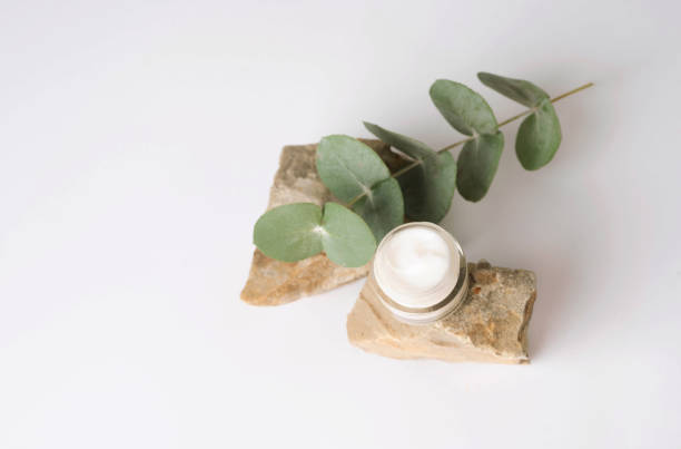 istock Skin care products, face moisturizer with open lid with eucalyptus on stone 1798862861