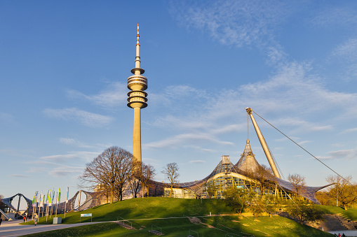 Munich, Germany - April 05, 2023: Olympiahalle with Olympic Tower in the Olympic Park in Munich. It is a multi-purpose arena. The Olympic Park was constructed for the 1972 Summer Olympics