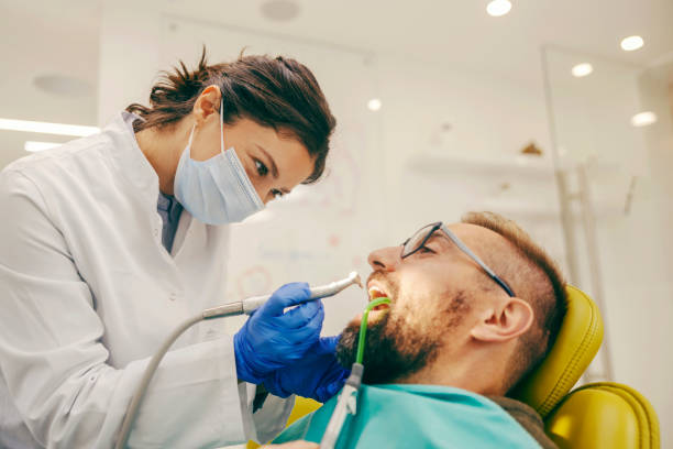 istock Dentist is drilling tooth with tooth caries while patient is sitting in chair. 1798878442