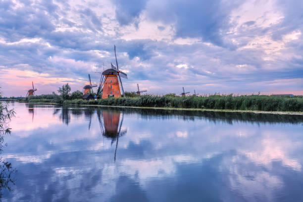 istock Windmill reflected in the water under a cloudy sky. Kinderdijk National Park in the Netherlands. Dutch canals. 1798894032