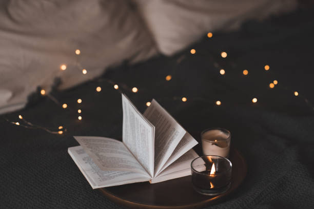 istock Open book with scented candle in bed 1798909857