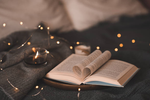 istock Paper book with heart folded pages with candle 1798909860