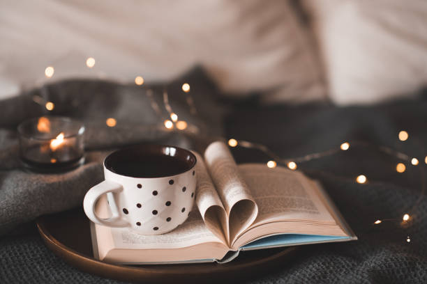 istock Cup of tea on book with heart folded pages 1798909861