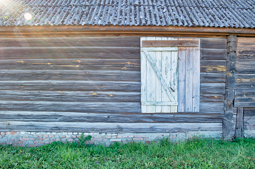 Travel Ideas. Old Wooden Door and Window In Countryside Area Over Old Brick Base. Horizontal image