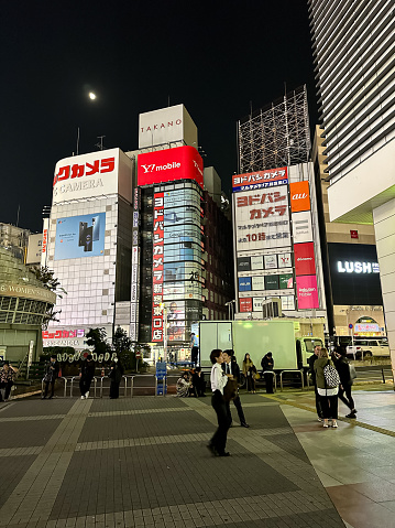 Tokyo, Japan - September 5, 2022 : Pedestrians walk past the Uniqlo store in Shinjuku-sanchome, Tokyo, Japan.