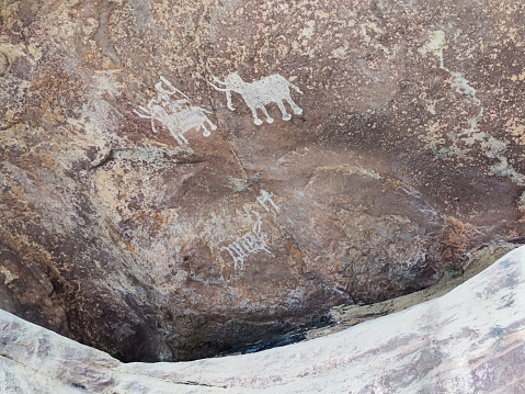 Indigenous people have been carving in rock for thousands of years as a means of written communication.  Petroglyphs are either images, designs or symbols chiseled, carved or scratched on the surface of the rock.  Many of these carvings have endured over the centuries and are still visible today.  The image on the right side of this rock depicts a round face.  Modern natives in this area identify this as a Kachina, or spirit being.  Research suggests that the Kachina Culture came to this area around 1300AD.  Similar Kachina symbols are used in modern Puebloan pottery and weavings which helps make the connection from past to present.  We don’t always know the true meaning of these carvings or how to interpret them.  And maybe it’s not our place to try.  We can however enjoy them for their artistry.  These petroglyphs were photographed at Puerco Pueblo in Petrified Forest National Park near Holbrook, Arizona, USA.