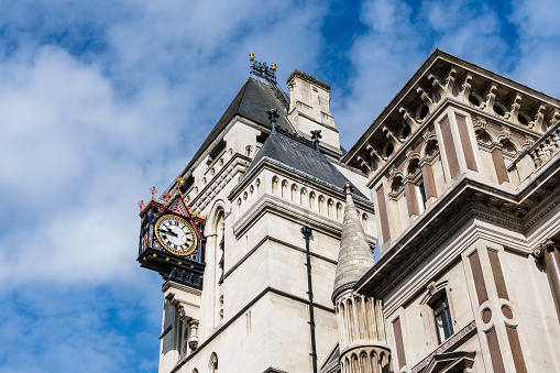 London, UK - August 25, 2023: Low angle view of The Royal Courts of Justice in the Strand. Clock