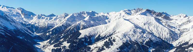 Panorama view from the Penken Mountain, Mayrhofen ski resort , into the Tuxer Valley and to the Hintertuxer Glacier ski resort. In the Valley the villages Finkenberg and Lanersbach and the Finkenberg ski resort.