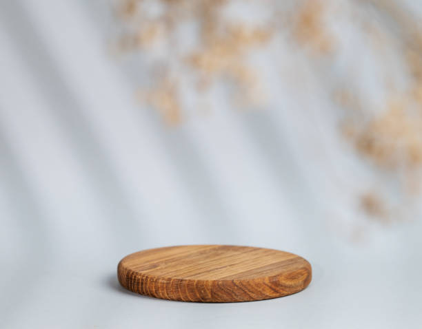 istock Abstract empty wooden board with shadows leaves on a gray background. Layout concept for promotional product presentation, sale or cosmetics display. 1798984780