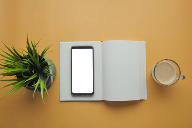 istock top view of smart phone with empty screen and notepad on table 1798992456