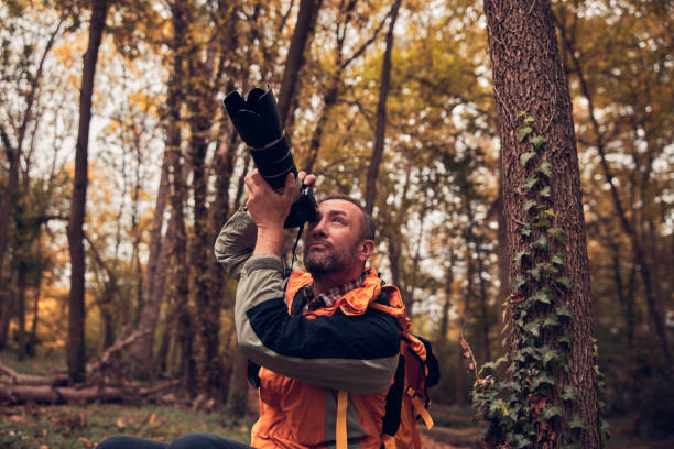 istock Man using camera for bird and animal photographing in nature. 1798992681