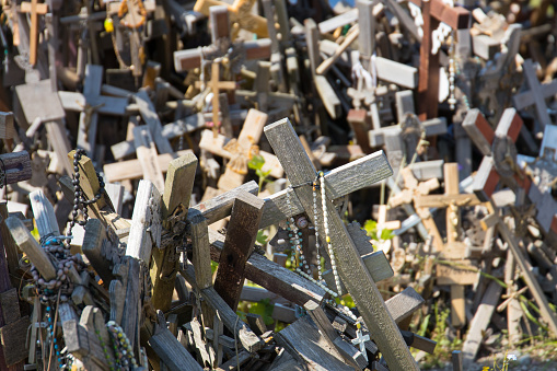 Religious symbols and many wooden crosses on the hill of crosses in Lithuania