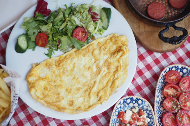 istock Omelet with vegetable salad in white plate on table 1799001564