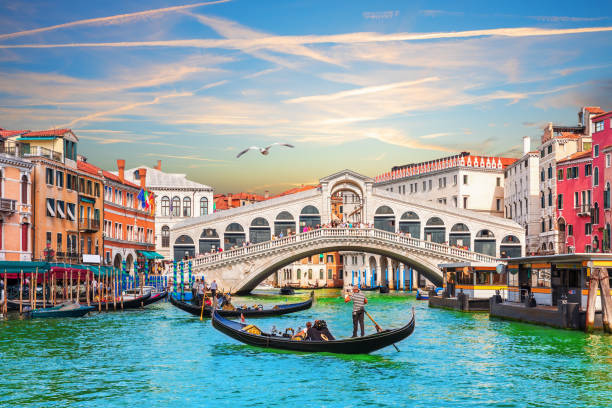 Sunset in the Grand Canal near the Rialto bridge, Venice, Italy Sunset in the Grand Canal near the Rialto bridge, Venice, Italy. gondola stock pictures, royalty-free photos & images
