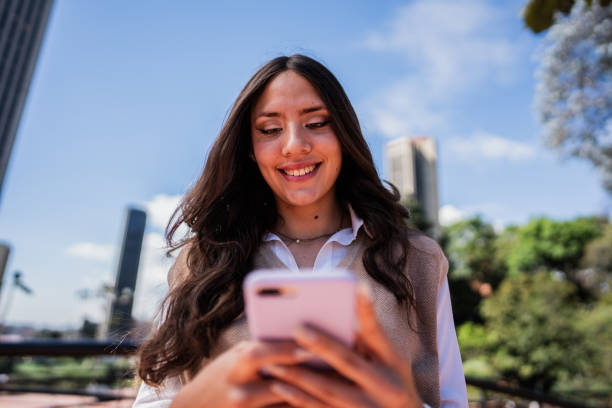 istock Young woman using mobile phone outdoors 1799019820