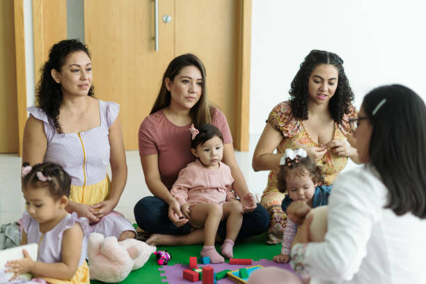 istock Three mothers and their babies attentively listen to a breastfeeding class. 1799022595