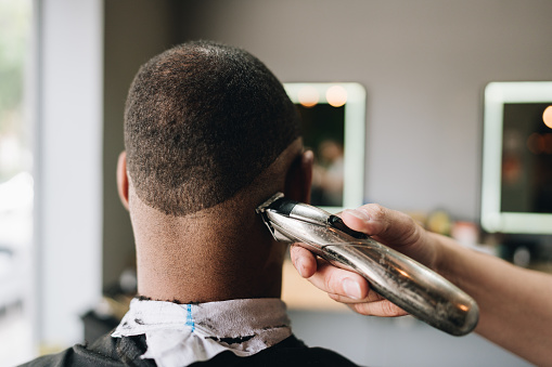 Man cutting his hair in a barber shop