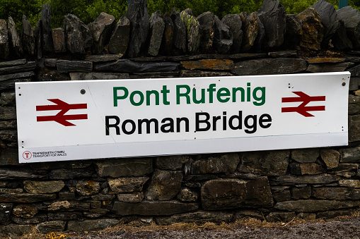 PONT RUFINEIG, WALES – JUN 14 2022: Sign for Roman Bridge Railway Station, landscape