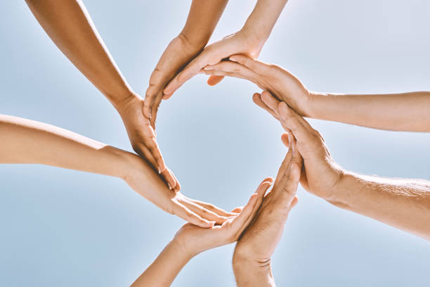 istock Hands, people and collaboration in trust circle for community, support and synergy on blue sky. Hope, hand and group with diversity, help and solidarity, environment and team effort blue background 1799087349
