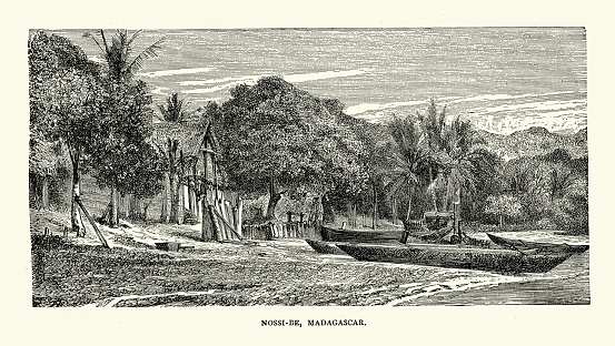 Vintage illustration Village and fishing boat on beach at Nosy Be, Madagascar, History 19th Century.  A bird's-eye View of Madagascar by M D Charnay