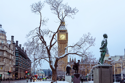 London transforms into a picturesque wonderland as delicate snowflakes blanket the city. The majestic Big Ben and Elizabeth Tower stands tall against the serene beauty of a snowy landscape, creating a magical scene that captures the essence of winter in the heart of the British capital.\nWinter in London, Snowfall, Big Ben, Snowy Landscape, Cityscape, Winter Wonderland, London Landmarks, Iconic Architecture, Seasonal Beauty, Urban Winter