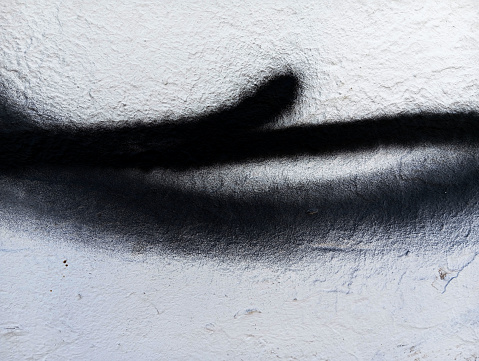 Black paint brush strokes on cement wall. Abstract black paint strokes background. Paint texture with copy space.