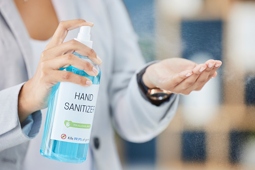Hand sanitizer, hand and business woman, covid and health, hygiene and cleaning hands at office, disinfect and safety from virus. Covid 19 compliance, disinfection at work with worker and healthcare.