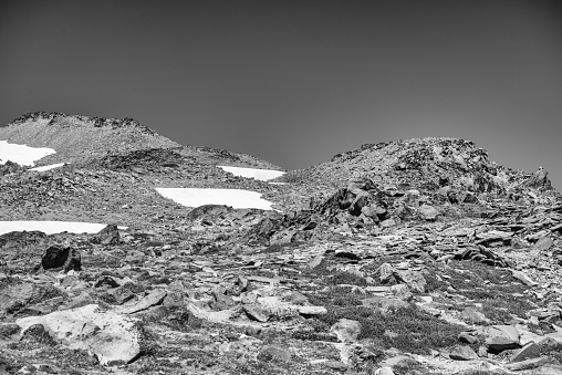 Desert landscape, with small, dry water tank in a tree area, Tunoco Mountain in the background