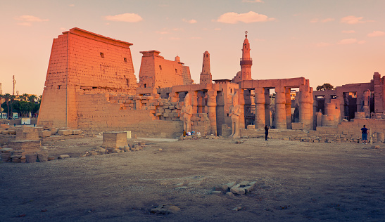 Luxor, Egypt - January 19, 2023: tourists discover the beauty of Luxor Temple at sunset