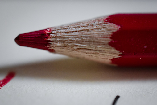 An abstract picture of a red colored coloring pencil on top of a desk