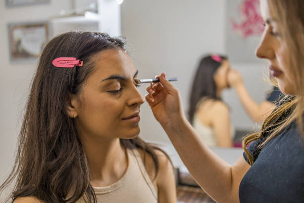 istock Make up artist apply a shadow  with blush on the client's eyelid. 1799244346
