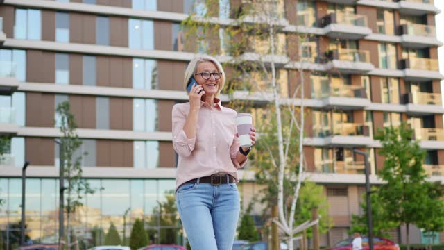 Mature woman talking on the phone outdoors