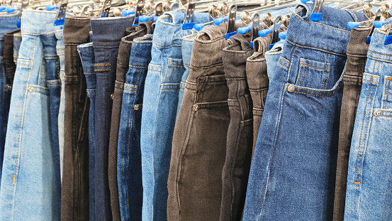 blue,  black and brown jeans denim trousers in a clothing store