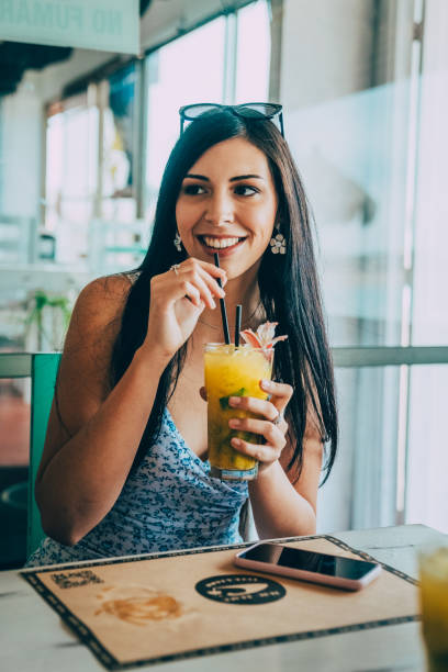 istock Relaxed woman enjoying having a drink. 1799299135