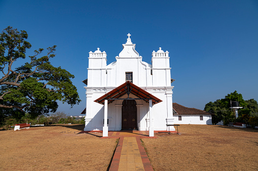 This image beautifully captures the Three Kings Chapel, perched atop Cansaulim Hill in Goa. This quaint and serene chapel is known for its panoramic views of the surrounding landscape and the Arabian Sea. Its simple yet elegant architectural style is a testament to Goa's rich religious and cultural history. The chapel, often bathed in the warm glow of the Goan sun, stands as a peaceful retreat and a popular destination for both locals and tourists. The photograph aims to convey the tranquil and spiritual atmosphere of the chapel, set against the stunning backdrop of Goa's natural beauty, making it a unique and must-visit spot in the region.