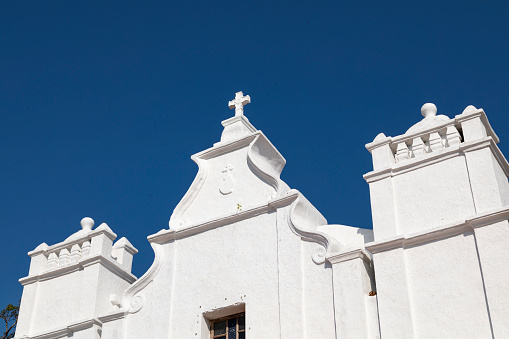 This image beautifully captures the Three Kings Chapel, perched atop Cansaulim Hill in Goa. This quaint and serene chapel is known for its panoramic views of the surrounding landscape and the Arabian Sea. Its simple yet elegant architectural style is a testament to Goa's rich religious and cultural history. The chapel, often bathed in the warm glow of the Goan sun, stands as a peaceful retreat and a popular destination for both locals and tourists. The photograph aims to convey the tranquil and spiritual atmosphere of the chapel, set against the stunning backdrop of Goa's natural beauty, making it a unique and must-visit spot in the region.