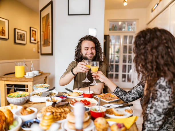 istock Young mixed race couple enjoying brunch at home 1799318319