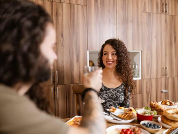 istock Young mixed race couple enjoying brunch at home 1799318335