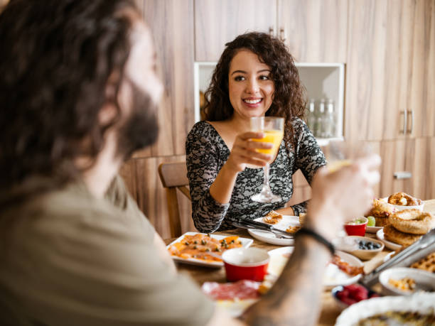istock Young mixed race couple enjoying brunch at home 1799320433