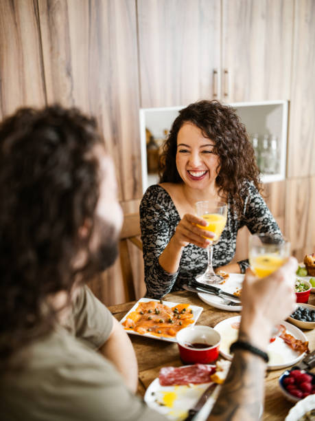 istock Young mixed race couple enjoying brunch at home 1799320434