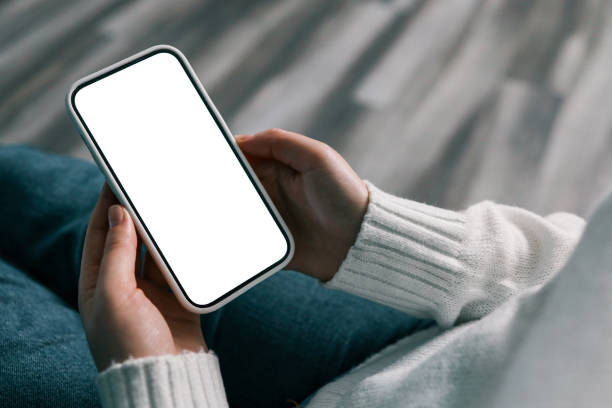 istock cell phone blank white screen mockup.woman hand holding texting using mobile at office 1799350298