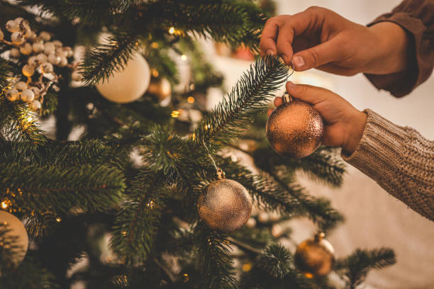 istock Mom and child decorate the Christmas tree 1799363374