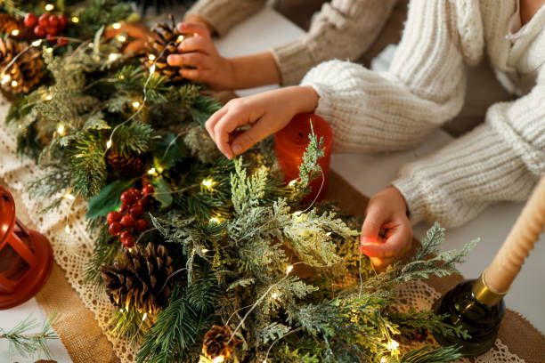 Children making a Christmas wreath, festive mood