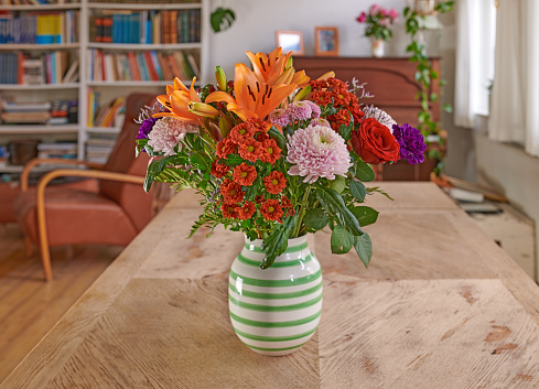 A bouquet of flowers on a dinning table in the livingroom