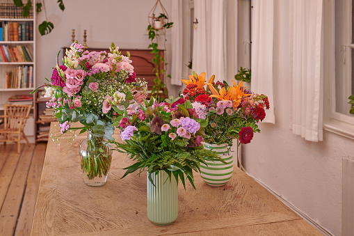 A bouquet of flowers on a dinning table in the livingroom