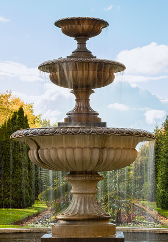 The three tiered water fountain statues in Regentâs park. which creates aesthetic atmosphere, Classic style stone fountain with flowing water, Vintage fountain, Copy space, Selective Focus.